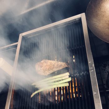 Wyld Child - a hamburger being cooked on a grill - Food Trucks Near Me