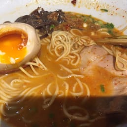 Big red spicy ramen with thin noodles, marinated soft boiled egg, green onions, & pig butt Big red spicy ramen with thin noodles, marinated soft boiled egg, green onions, & pig butt
