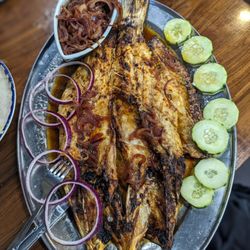 Coni'Seafood - Pescado zarandeado. Grilled snook with salt and house sauce served with caramelized onions and tortillas.