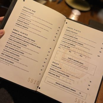 Suyo Modern Peruvian - a person holding a menu - Peruvian Near Me - Vancouver, British Columbia Suyo Modern Peruvian - a person holding a menu - Peruvian Near Me - Vancouver, British Columbia