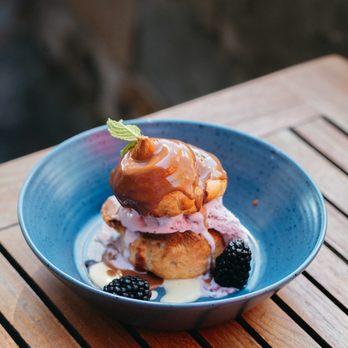 The Firebrand Hotel - Luxurious Firebrand Dessert - Montana Profiterol - Huckleberry ice cream between puff pastry with crème anglaise & chocolate - Hotels Near Me - Whitefish, Montana The Firebrand Hotel - Luxurious Firebrand Dessert - Montana Profiterol - Huckleberry ice cream between puff pastry with crème anglaise & chocolate - Hotels Near Me - Whitefish, Montana