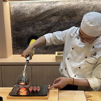 Sushi Izuki - Chef preparing the seared Wyagu beef. - Sushi Bars Near Me - Orlando, Florida Sushi Izuki - Chef preparing the seared Wyagu beef. - Sushi Bars Near Me - Orlando, Florida