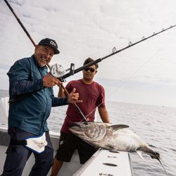 Outcast Sportfishing - Tanner hauling aboard another BFT for a happy angler