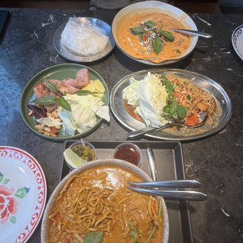 Isarn Thai Soul Kitchen - *top to bottom: chu chi red curry dinner with sticky rice, isarn pork sausage, thai green papaya salad and kao soi - Thai Near Me - Seattle, Washington
