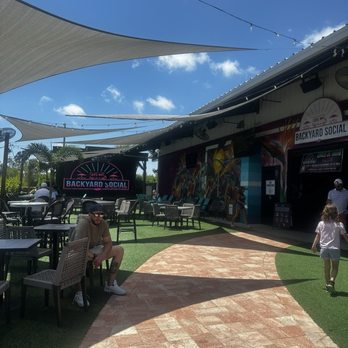 Backyard Social - outdoor seating area with jumbotron - Food Trucks Near Me - Fort Myers, Florida