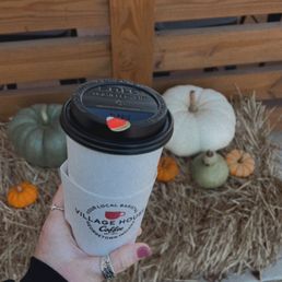 a hand holding a cup of coffee a hand holding a cup of coffee
