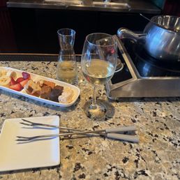 Bar area with a glass of Kim Crawford, Pinot Grigio, Venezie, ITA and Classic Alpine* cheese fondue. Bar area with a glass of Kim Crawford, Pinot Grigio, Venezie, ITA and Classic Alpine* cheese fondue.