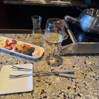 The Melting Pot - Bar area with a glass of Kim Crawford, Pinot Grigio, Venezie, ITA and Classic Alpine* cheese fondue. - Fondue Near Me - Arlington, Virginia The Melting Pot - Bar area with a glass of Kim Crawford, Pinot Grigio, Venezie, ITA and Classic Alpine* cheese fondue. - Fondue Near Me - Arlington, Virginia