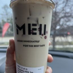 a hand holding a cup of coffee