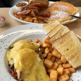 a plate of food with eggs, pancakes, and hash browns
