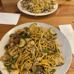 a plate of noodles with mushrooms and zucchini a plate of noodles with mushrooms and zucchini
