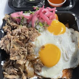 Carnitas mixta chilaquiles egg sunny side up.