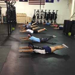 Crossfit Hyattsville - 5:30am class working on their superman and hollow body positions this morning--tight core, arms straight, feet together, toes pointed.