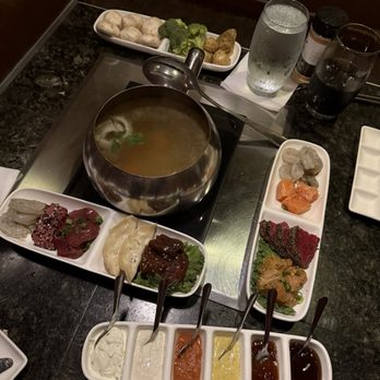 The Melting Pot - Pacific Rim (left), sauces (bottom), surf and turf (right), veggies (top) and court bouillon cooking method. - Fondue Near Me - Sacramento, California The Melting Pot - Pacific Rim (left), sauces (bottom), surf and turf (right), veggies (top) and court bouillon cooking method. - Fondue Near Me - Sacramento, California