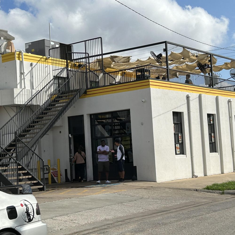 Burger Bodega - Outside seating up the stairs. Inside, there's only about 25 cramped seats. - Burgers Near Me - Houston, Texas
