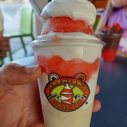 Pina colada on bottom, and strawberry on top, with vanilla soft serve