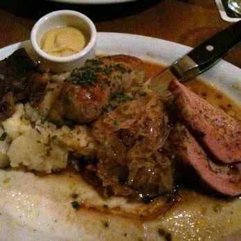 Leopold's - Choucroute Garni Platter - pork ribs, smoked pork loin and house-made bratwurst with sauerkraut and butter caraway potatoes - German Near Me - San Francisco, California Leopold's - Choucroute Garni Platter - pork ribs, smoked pork loin and house-made bratwurst with sauerkraut and butter caraway potatoes - German Near Me - San Francisco, California