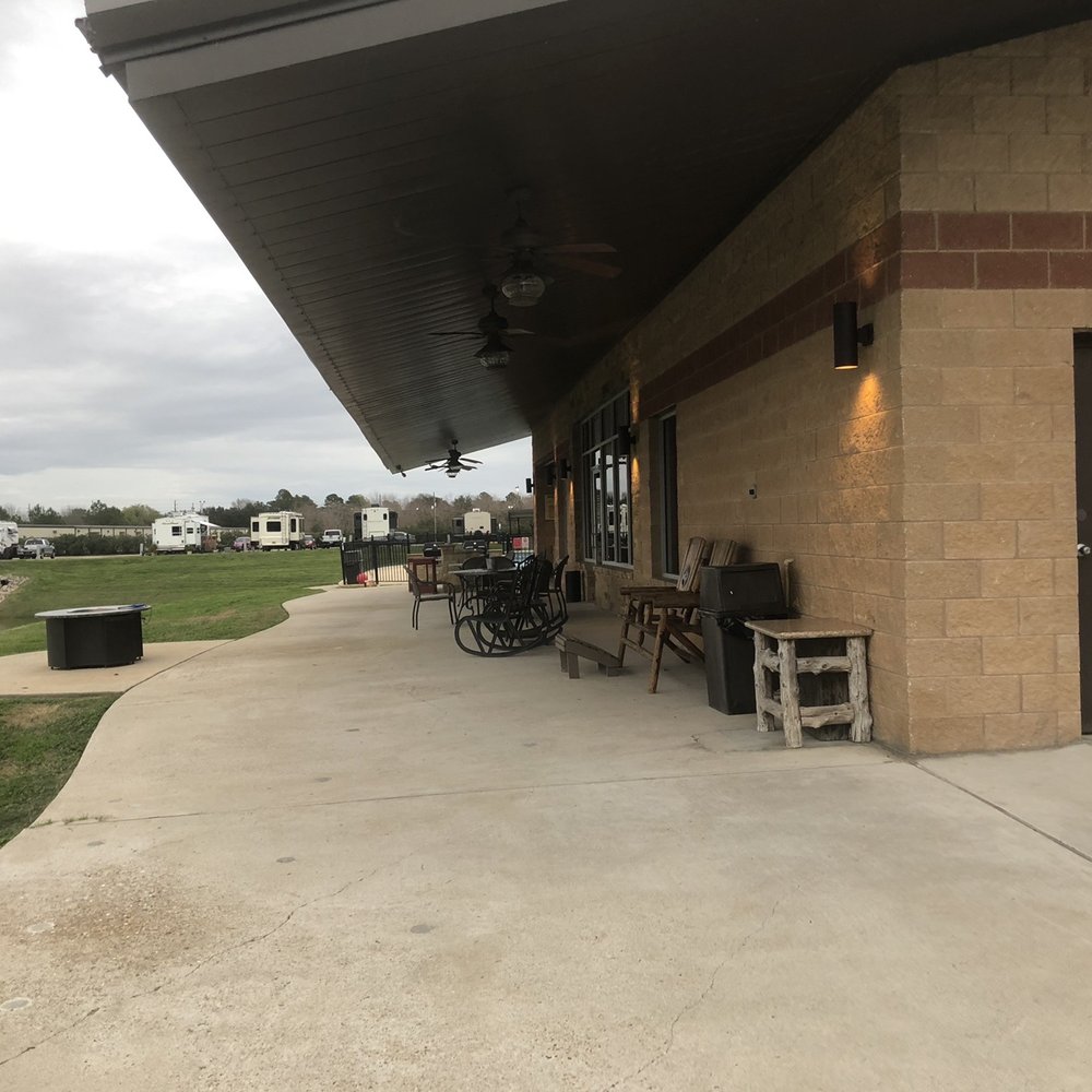 Katy Lake RV Resort - The activity center, pool area, showers/restrooms, and laundry facilities. - RV Parks Near Me - Katy, Texas