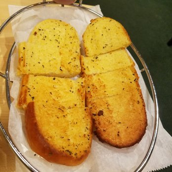 Monical's Pizza - four slices of bread on a wire basket - Pizza Near Me - Bloomington, Illinois