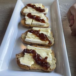 Hard toast, randomly cut Brie and fig jam that looks like my toddler placed on there.