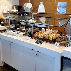 Delta Sky Club - Breakfast Spread. Hot Plates Were Country Fried Potatoes, Omelet Egg Bites, Breakfast Sausage Patties and Fake Sausage Patties