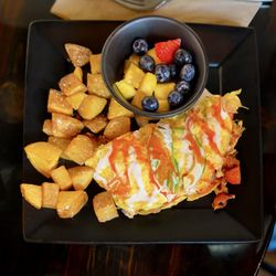 Goat Head - The Forbidden One omelet - grilled chicken, bacon, tomatoes, and Jack cheese, topped with avocado, Cholula, and bleu cheese vinaigrette