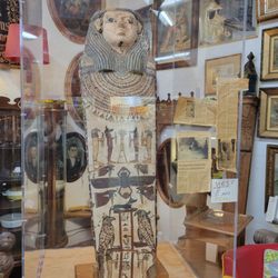 Sanford and Son Antiques - A real sarcophagus encased in glass.