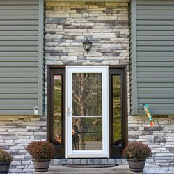 Maven Building Supply - Entry surrounded by stone veneer and premium vinyl siding