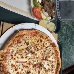 Raphael's Italian Restaurant - Pizza with Canadian bacon and sausage. Gyro salad with Tzatziki sauce.