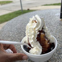 a hand holding a spoon