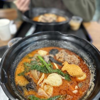 YGF Malatang - a person eating a bowl of soup - Noodles Near Me - Milpitas, California YGF Malatang - a person eating a bowl of soup - Noodles Near Me - Milpitas, California