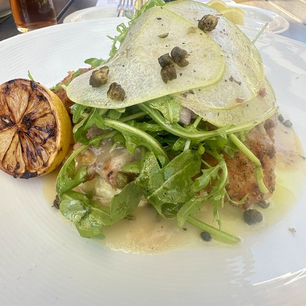 The Grove Kitchen & Gardens - Chicken Milanese topped with a pear arugula salad - American Near Me - Tyler, Texas The Grove Kitchen & Gardens - Chicken Milanese topped with a pear arugula salad - American Near Me - Tyler, Texas