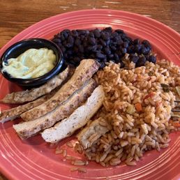 This is Spanish rice, black beans, chicken, and tahini sauce, it is so delicious I have you Recomended