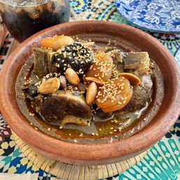 Lamb tajine with almonds, prunes and apricots in a savory sauce.