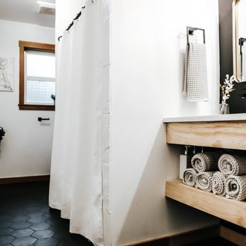 Renco - a bathroom with black and white tile flooring - General Contractors Near Me Renco - a bathroom with black and white tile flooring - General Contractors Near Me