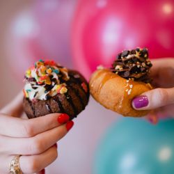 The Cupcake Bar - Two people "cheers" with their custom doughnuts from The Cupcake Bar at a party in Austin, Texas