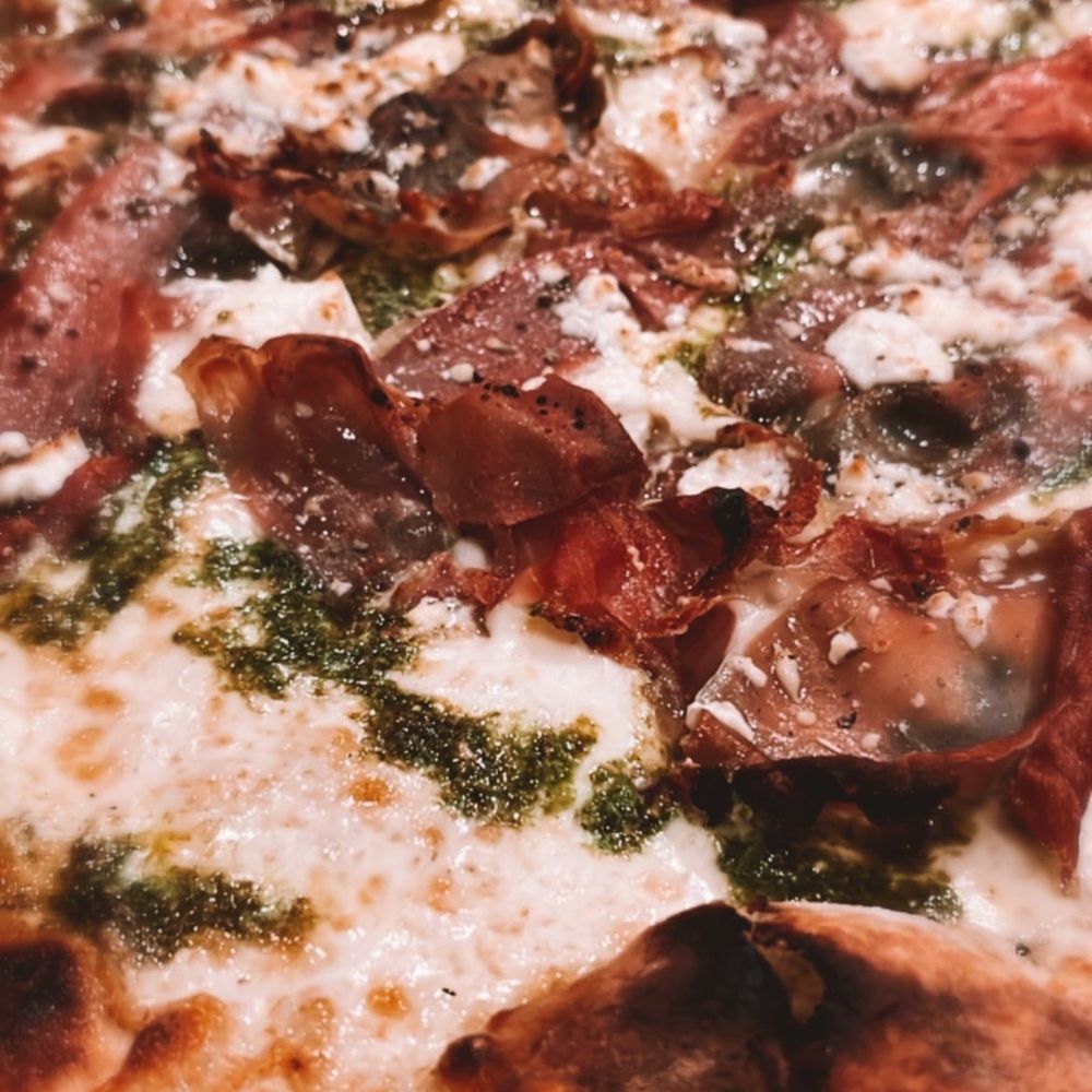 1943 Pizza Bar - White Pie with Garlic, Basil Pesto, Prosciutto, Goat Cheese - Pizza Near Me - Greenport, New York 1943 Pizza Bar - White Pie with Garlic, Basil Pesto, Prosciutto, Goat Cheese - Pizza Near Me - Greenport, New York