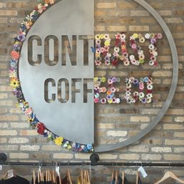 a circular sign with flowers on it a circular sign with flowers on it