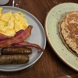 Scrambled eggs, bacon, pork sausage, and pancakes. Scrambled eggs, bacon, pork sausage, and pancakes.