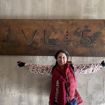 Hotel Chaco - Me with sign to upstairs bar - Venues & Event Spaces Near Me - Albuquerque, New Mexico