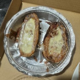 $13 for one potato cut in two cheese human hairs and bacon.