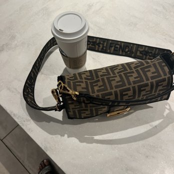 Starbucks - a cup of coffee and a handbag on a table - Coffee & Tea Near Me - Century City, California Starbucks - a cup of coffee and a handbag on a table - Coffee & Tea Near Me - Century City, California