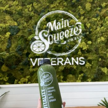 Main Squeeze Juice Co. - a person holding a bottle of green juice - Juice Bars & Smoothies Near Me - Metairie, Louisiana Main Squeeze Juice Co. - a person holding a bottle of green juice - Juice Bars & Smoothies Near Me - Metairie, Louisiana