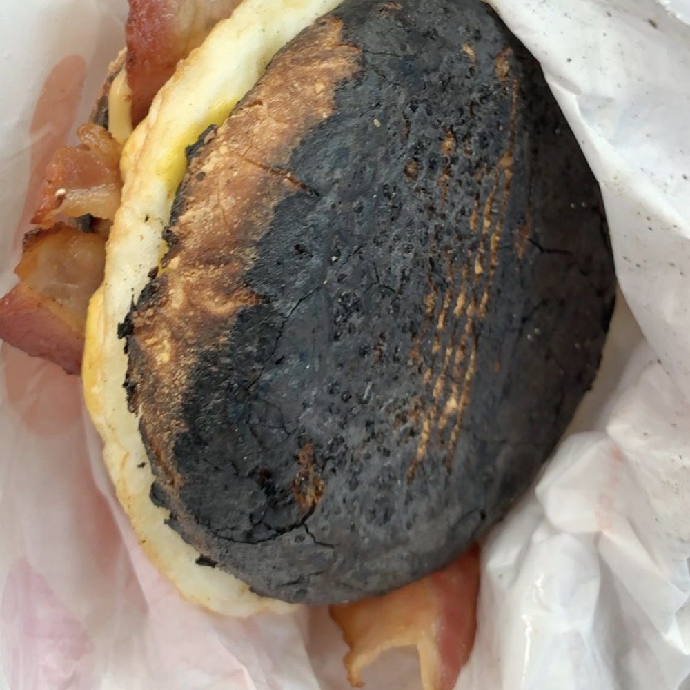 a bacon and egg sandwich wrapped in wax paper a bacon and egg sandwich wrapped in wax paper