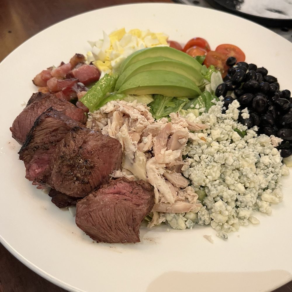 Corinne Austin - Corinne Cobb with steak - New American Near Me - Austin, Texas