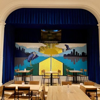 Central Waters Brewing Milwaukee - a stage with tables and chairs - Brewpubs Near Me - Milwaukee, Wisconsin