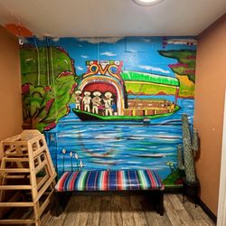 Los Alambres - The mural of Xochimilco and bench with woven blanket are a really charming touch to this family restaurant