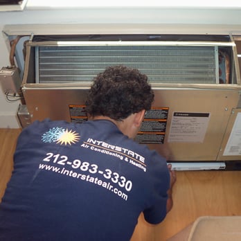 Interstate Air Conditioning & Heating - HVAC Technician Performing Air Conditinoing Maintenance on a PTAC (Through-The-Wall) HVAC unit in Manhattan - Heating & Air Conditioning/HVAC Near Me - New York, New York Interstate Air Conditioning & Heating - HVAC Technician Performing Air Conditinoing Maintenance on a PTAC (Through-The-Wall) HVAC unit in Manhattan - Heating & Air Conditioning/HVAC Near Me - New York, New York