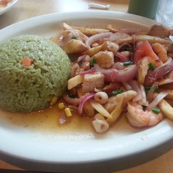 Inkas - Saltado Seafood Combination of fish strips, calamari, and shrimp sautéed w/ cilantro rice - Peruvian Near Me - Irvine, California