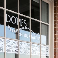 Dopps Chiropractic - Front window of Dopps Chiropractic displays a list of common conditions treated at the clinic, emphasizing the broad range of chiropractic.